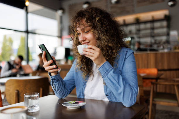 a woman is reading news from mobile apps